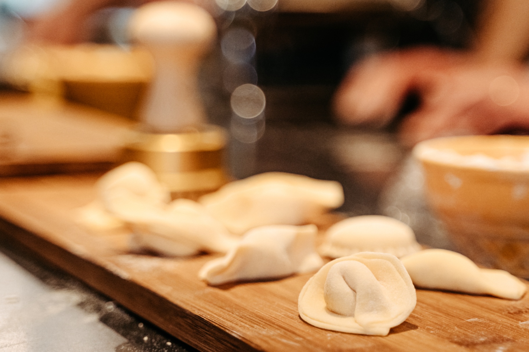 Freshly shaped agnolotti resting on a board