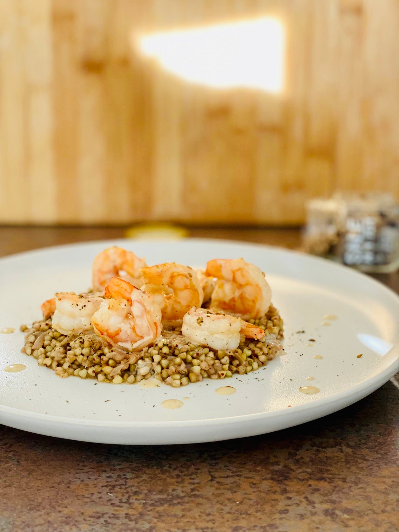 PRAWNS COOKED WITH SEA SALT WITH 4 PEPPER, RHUM AND SERVED WITH BUCKWHEAT